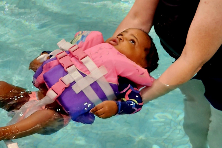 young girl floating in pool