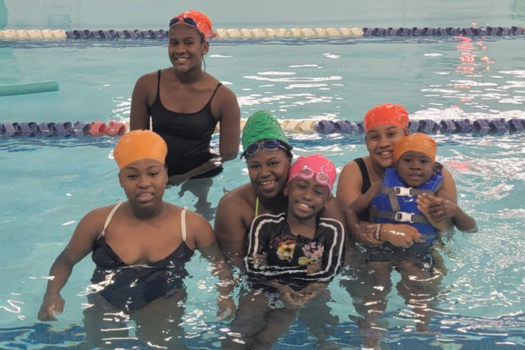 Family photo in pool smiling