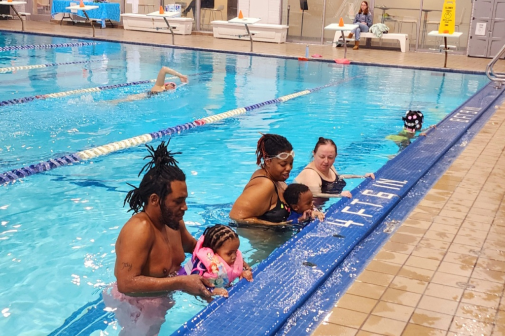 Family walking wall during swim lesson